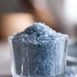 close-up of blue salt crystals in a classic glass cup