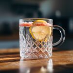 Glass of pink Himalayan salt water on kitchen table – himalayan salt hack recipe